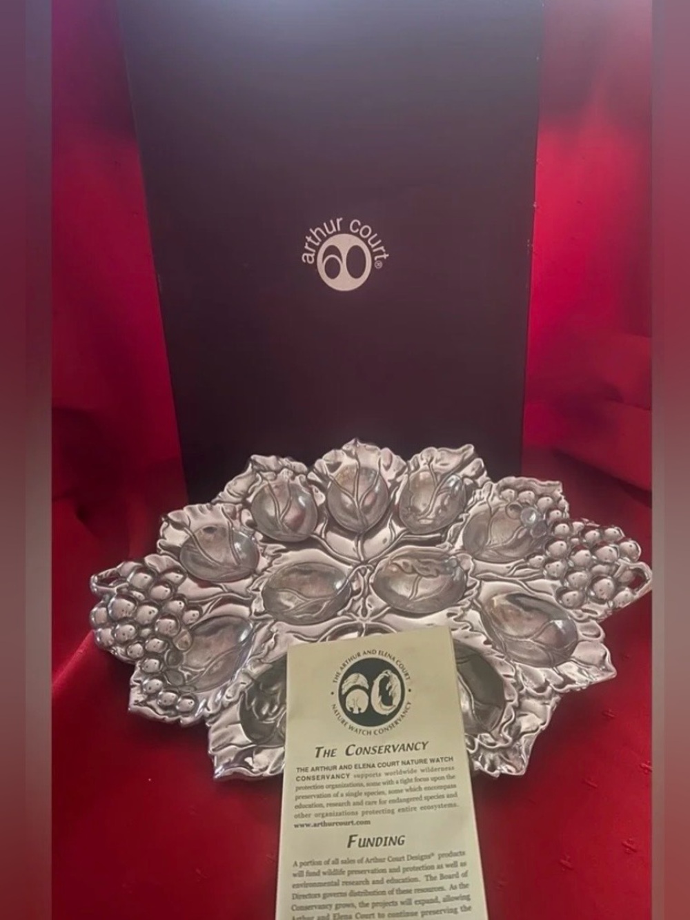 Silver platter with intricate floral and grape design